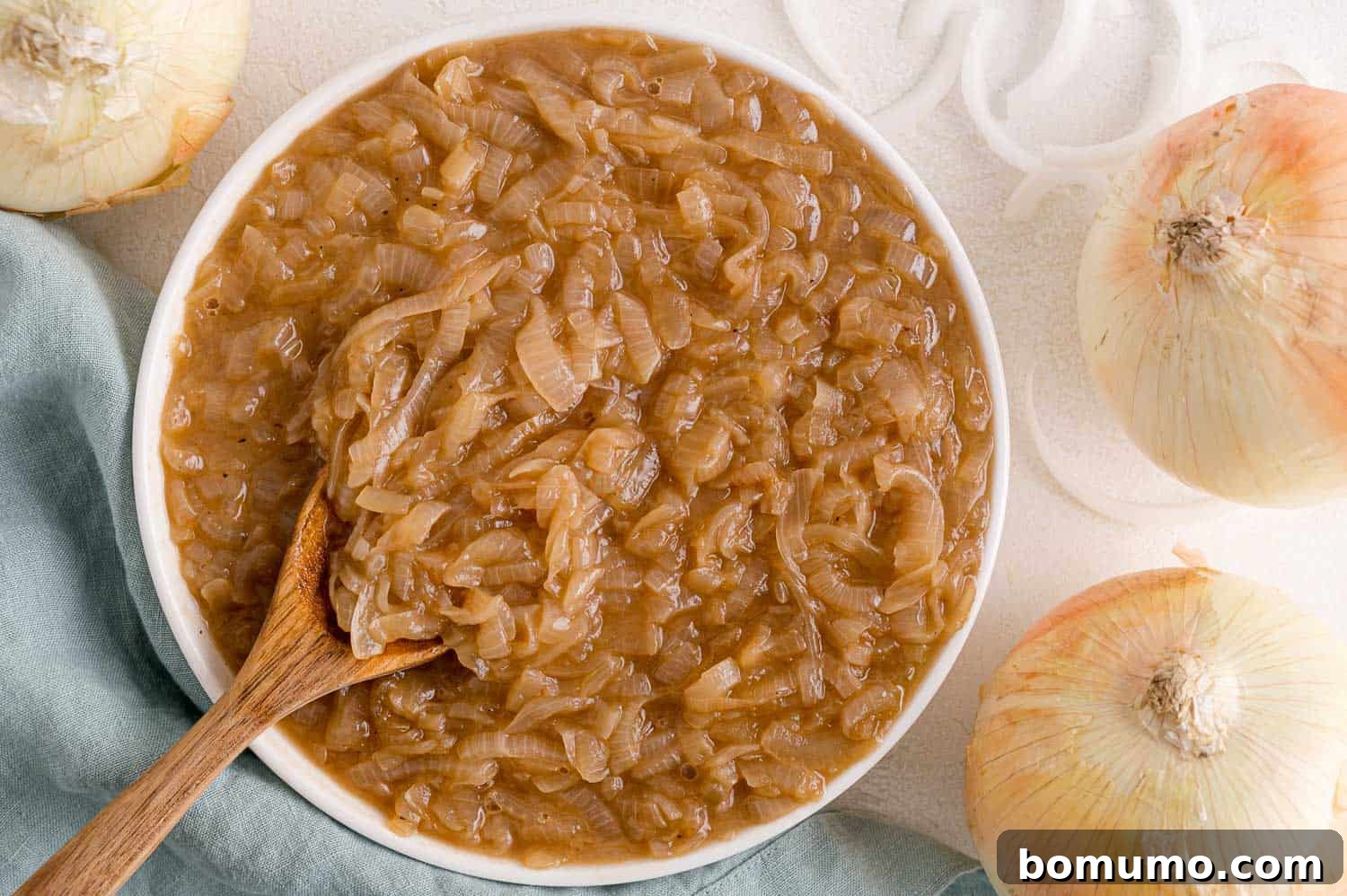 Caramelizing Onions: A Comprehensive Guide 13 Caramelized onions in a bowl with wooden spoon