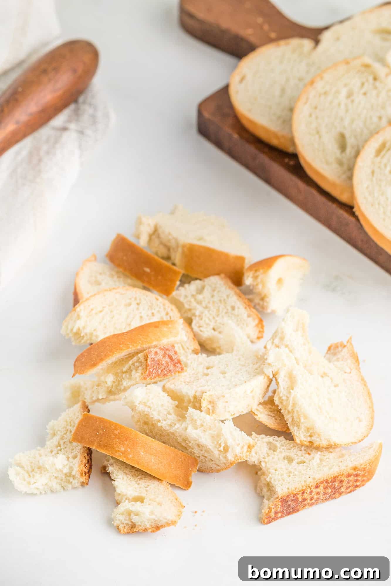 Torn bread on a white surface.