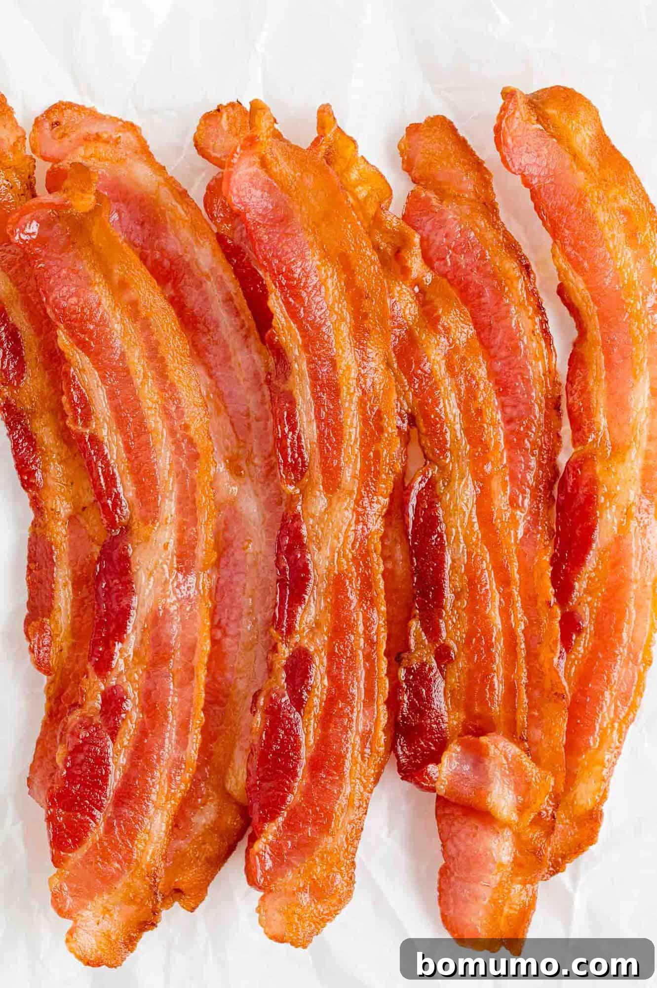 Crispy Air Fried Bacon 2 Crispy Air Fryer Bacon on a clean white background, ready to be enjoyed.