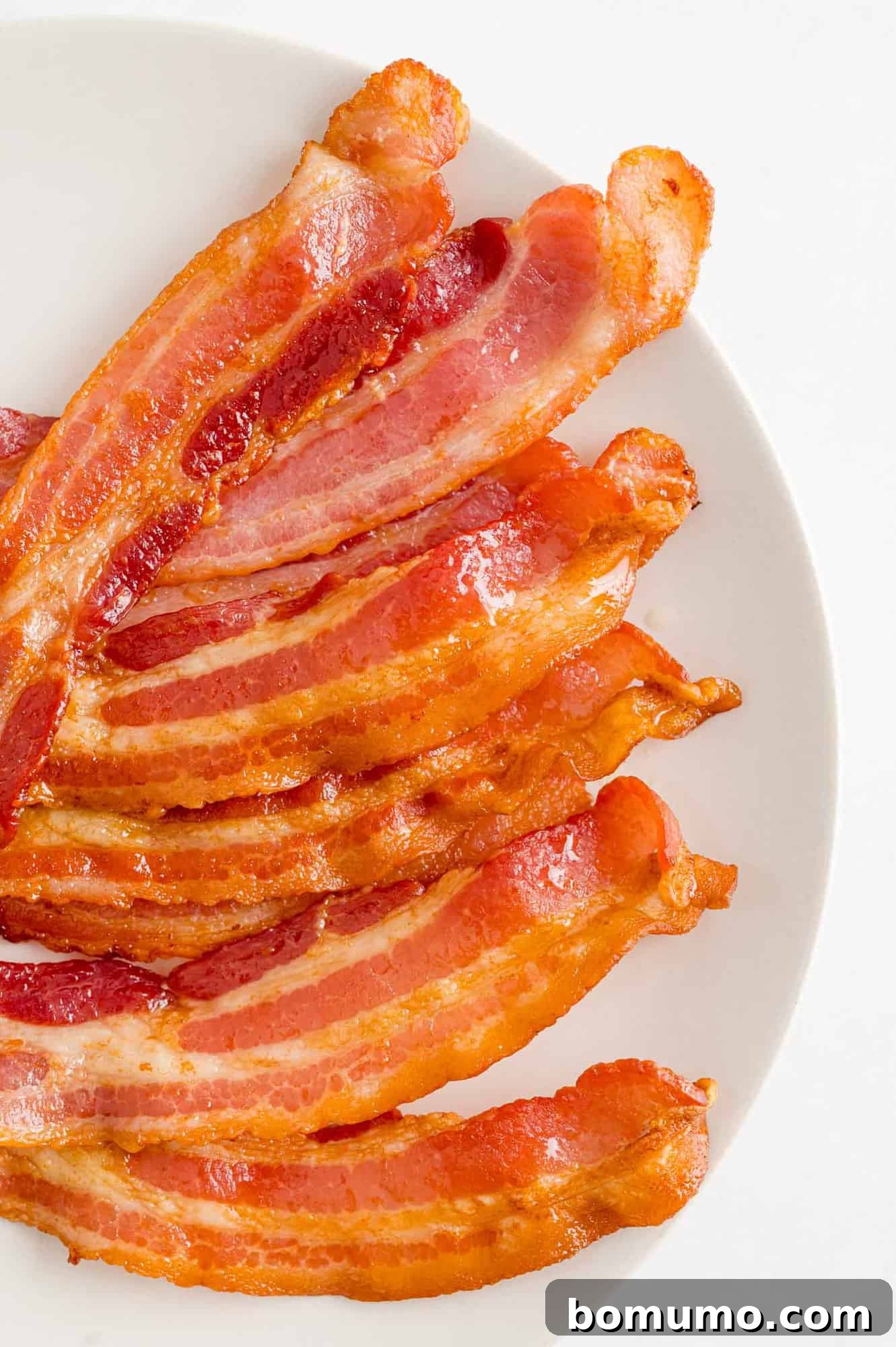 Crispy Air Fried Bacon 10 Crispy bacon elegantly arranged on a white platter.