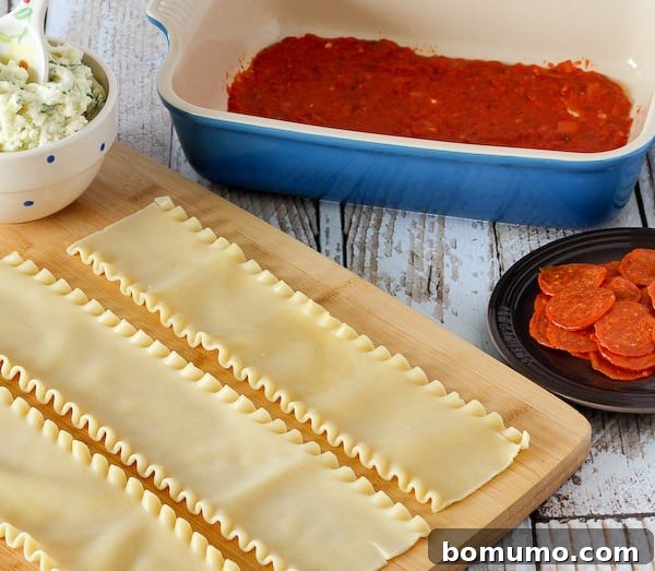 Cooked lasagna noodles laid out on a wooden cutting board.