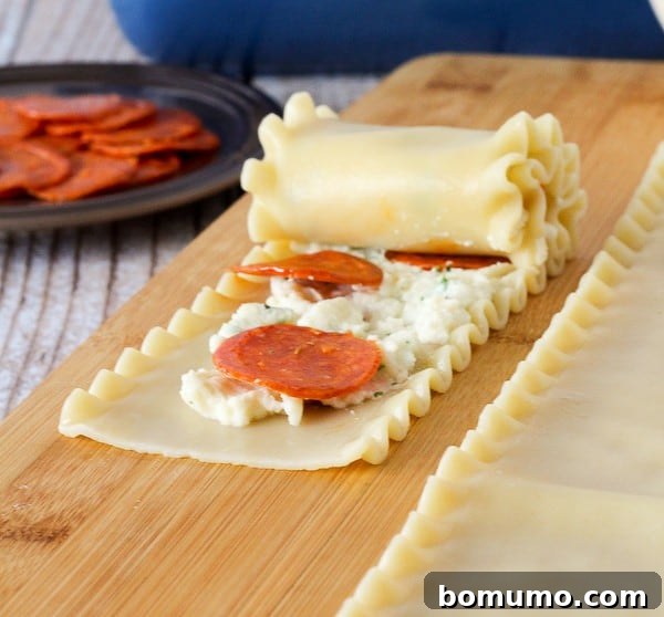 Pepperoni pizza roll being rolled up.