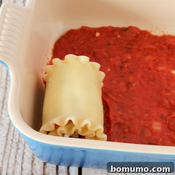 Rolled lasagna roll in pizza sauce.