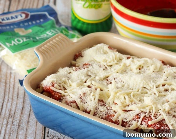 Cheese added to the top of the pepperoni pizza lasagna rolls.