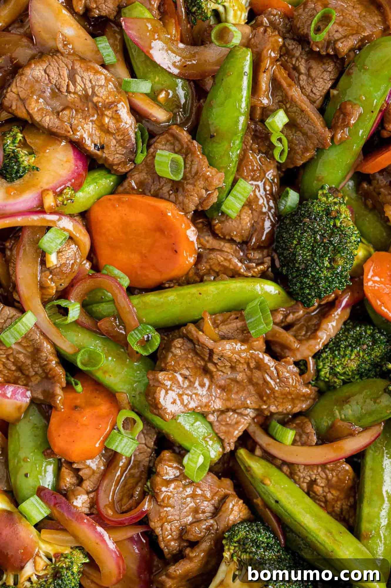 Delicious beef and vegetable stir fry filling the frame, ready to be served.