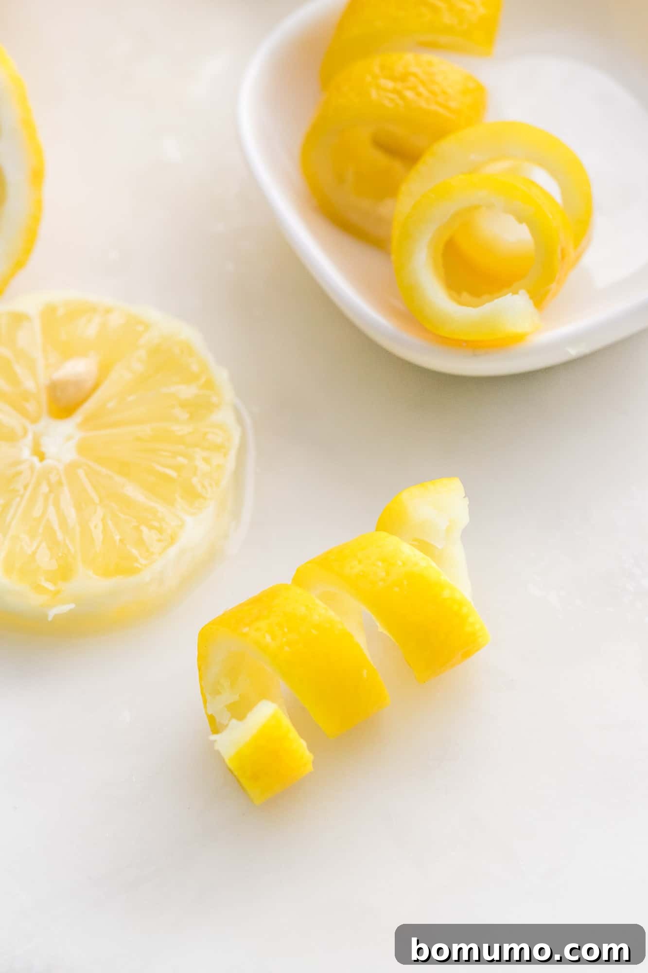 Lemon twist on a white surface.