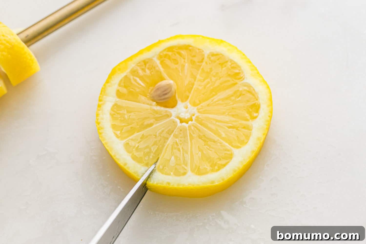 Slit being cut in a lemon wheel.