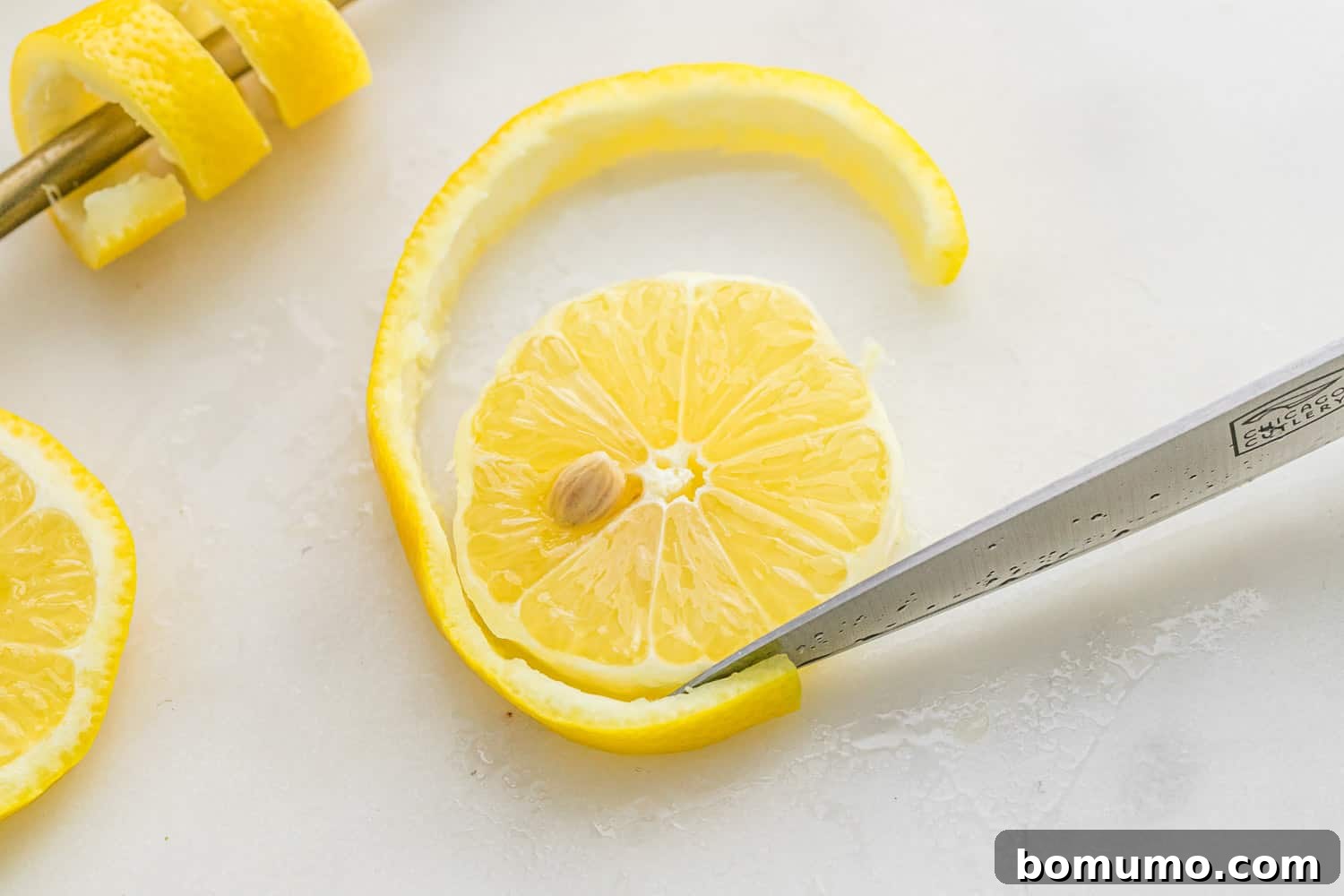 Peel being cut off a lemon wheel.