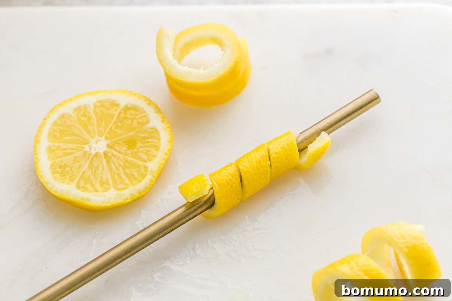 Lemon peel wrapped around a straw.