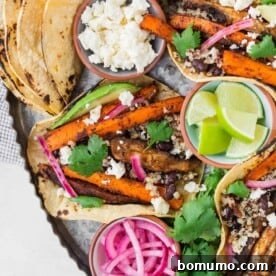 Delicious roasted carrot and mushroom tacos arranged on a tray with a variety of fresh toppings.