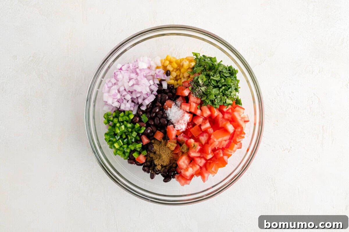 Fiesta Black Bean Corn Salsa 5 All the freshly chopped and prepped salsa ingredients gathered in a mixing bowl, prior to being stirred.