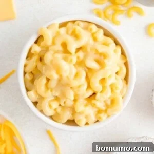 Creamy microwave mac and cheese in a white bowl.