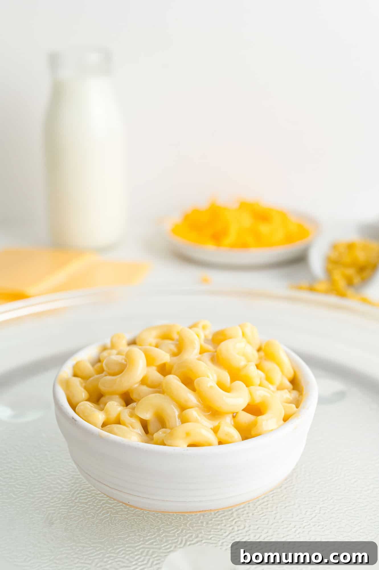 Mac in cheese in a small white bowl, ready to eat.