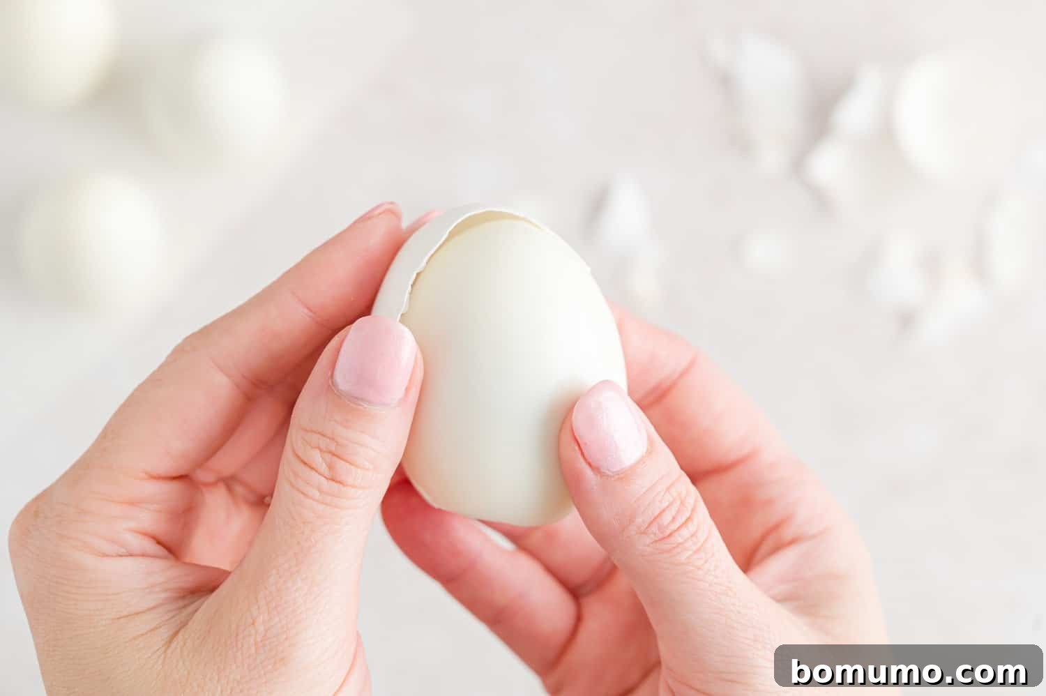 Hard boiled egg being peeled.
