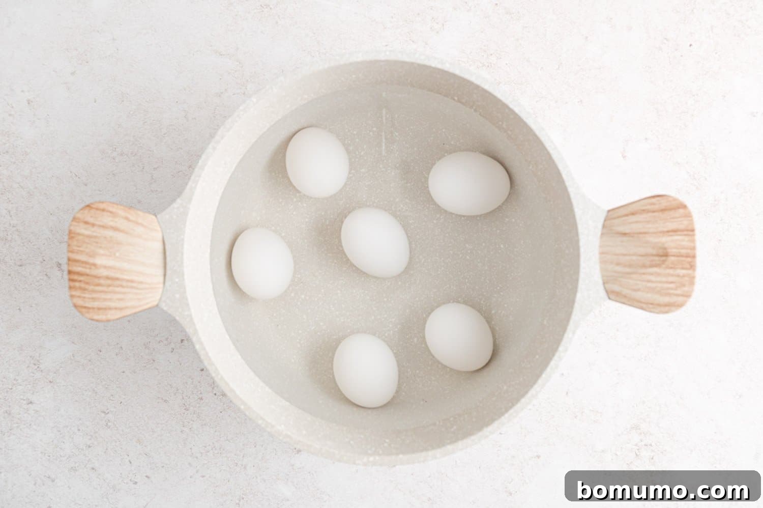 Eggs in pan with water.