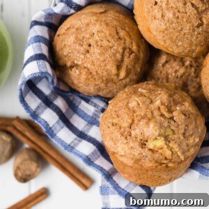 Overhead view of muffins in a basket with blue and white linen.