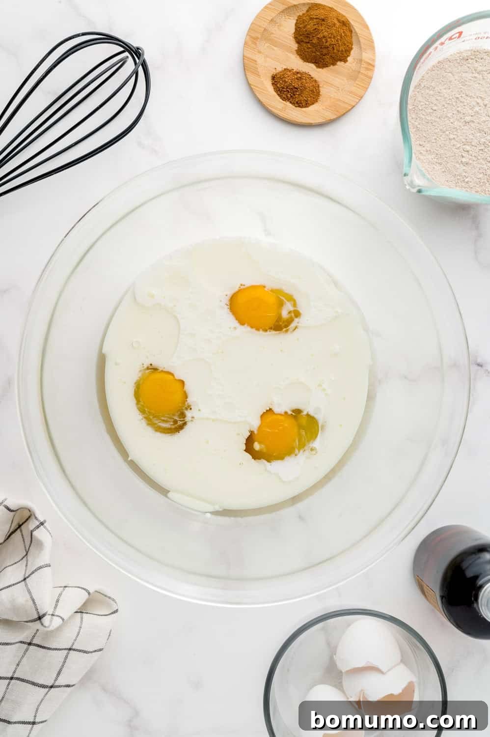 Wet ingredients (eggs, oil, milk, maple syrup) separately in a bowl before mixing.