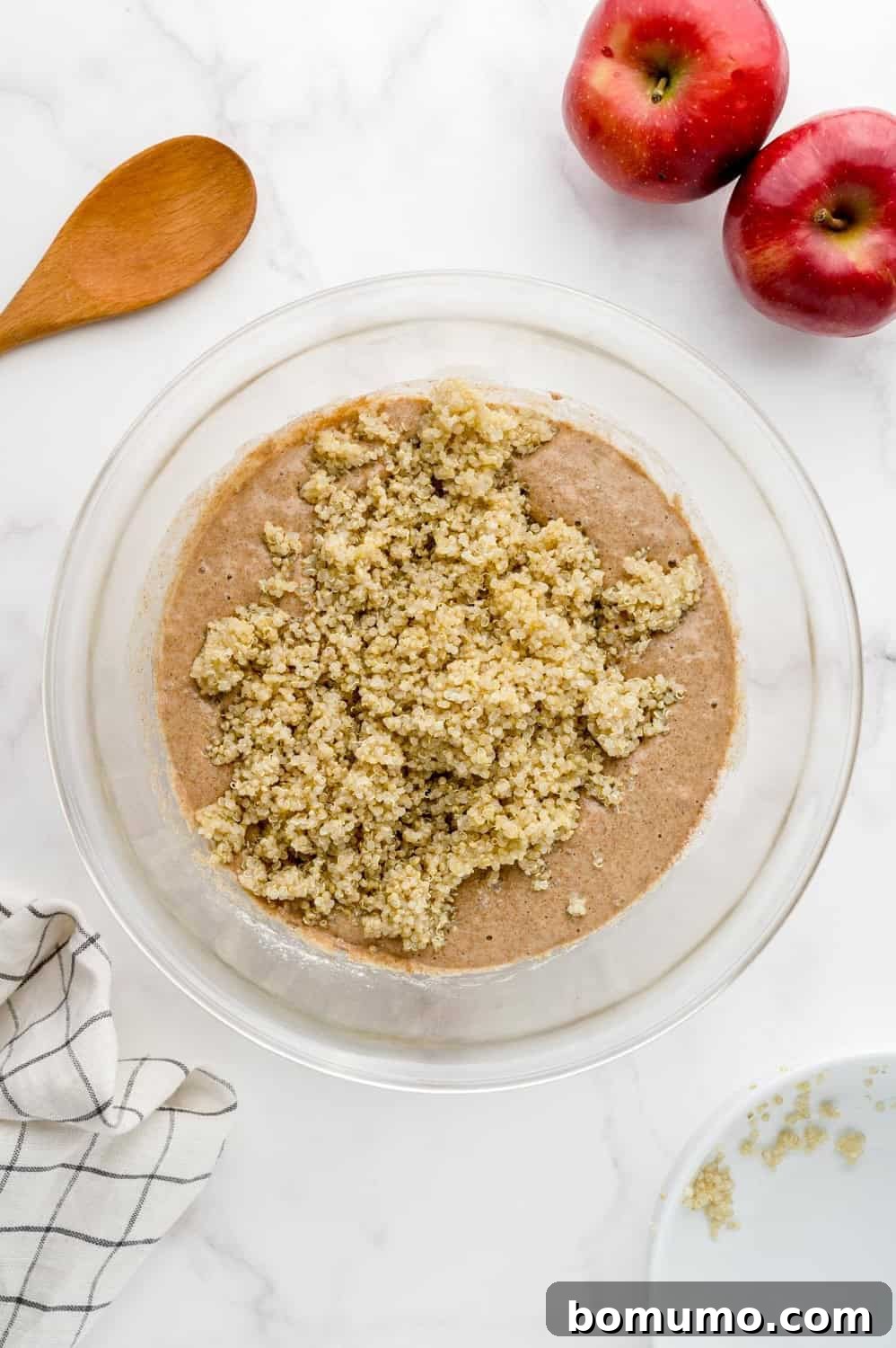 Cooked quinoa added to the batter, waiting to be mixed in.