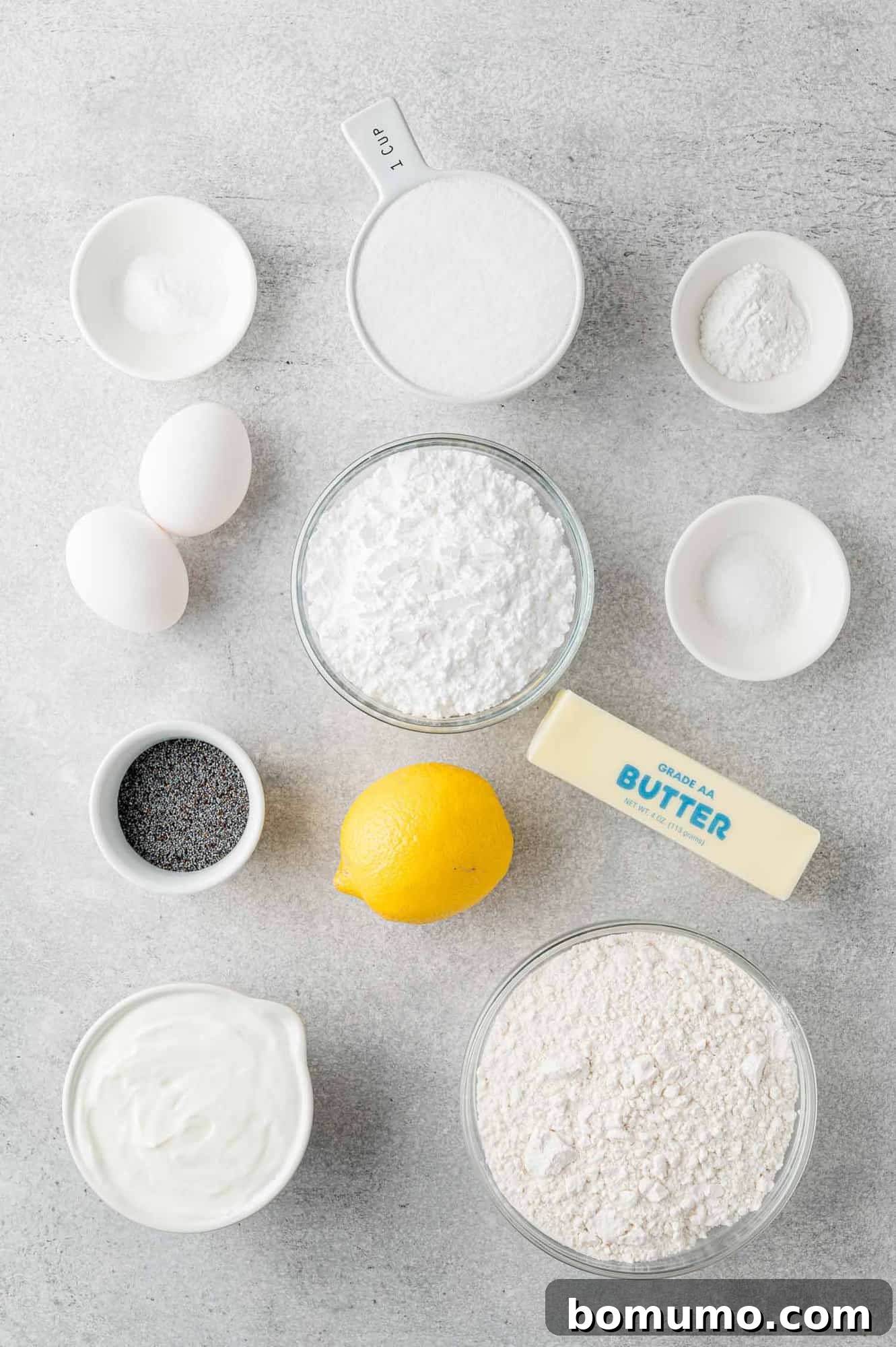 An overhead shot showcasing all the fresh ingredients perfectly laid out on a clean counter, ready for baking this lemon poppy seed bread.