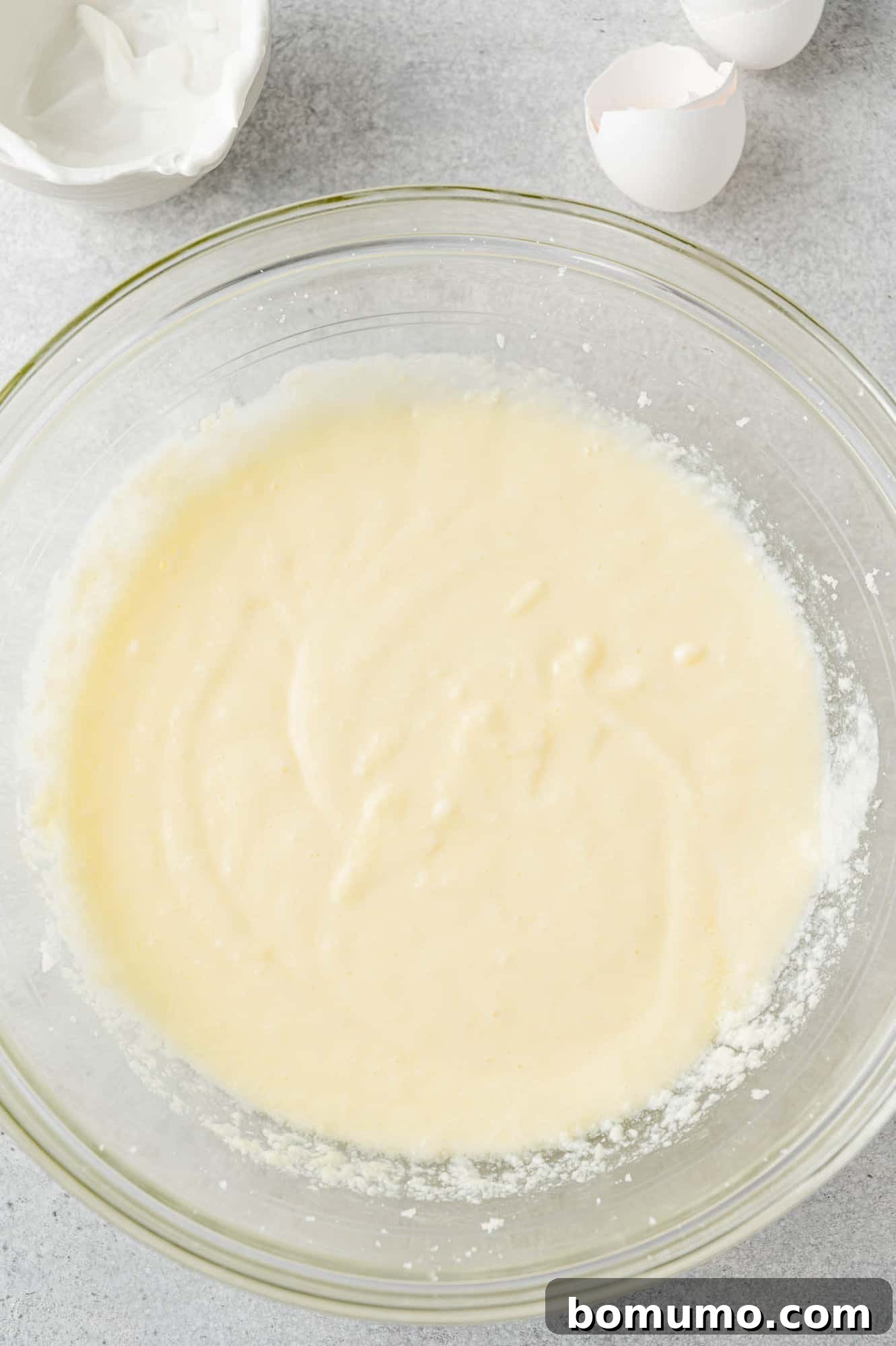 The egg has been fully mixed into the butter and sugar mixture, creating a smooth, cohesive batter.