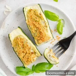 Cheese and pesto stuffed zucchini, cut to show filling.