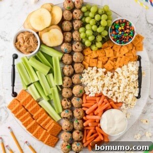 Round snack board with a variety of items.