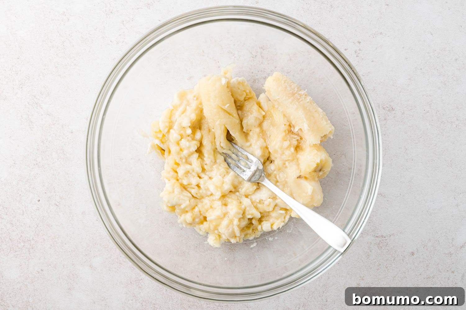 Banana being mashed for muffins.