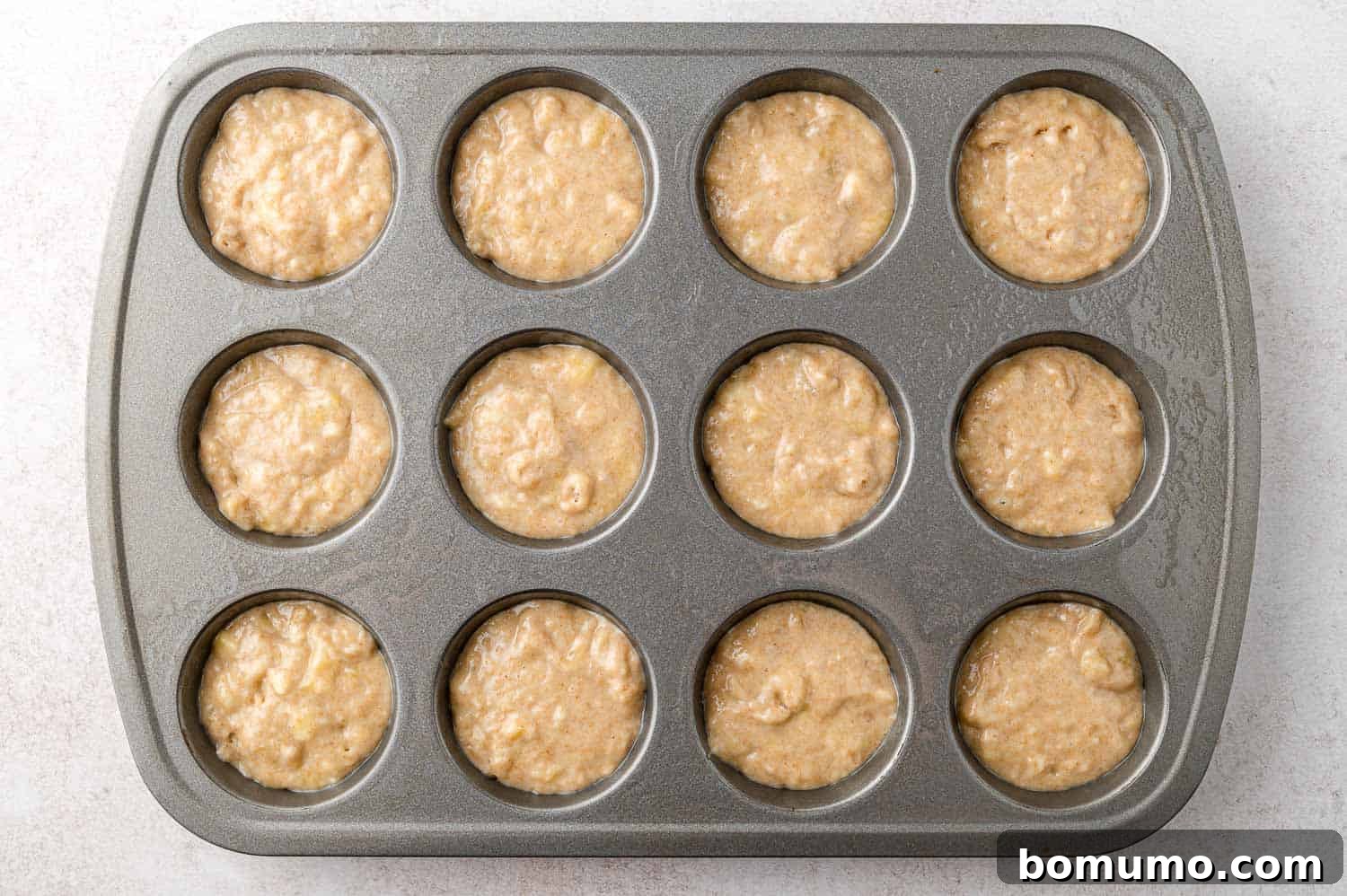 Unbaked muffins in muffin tin.