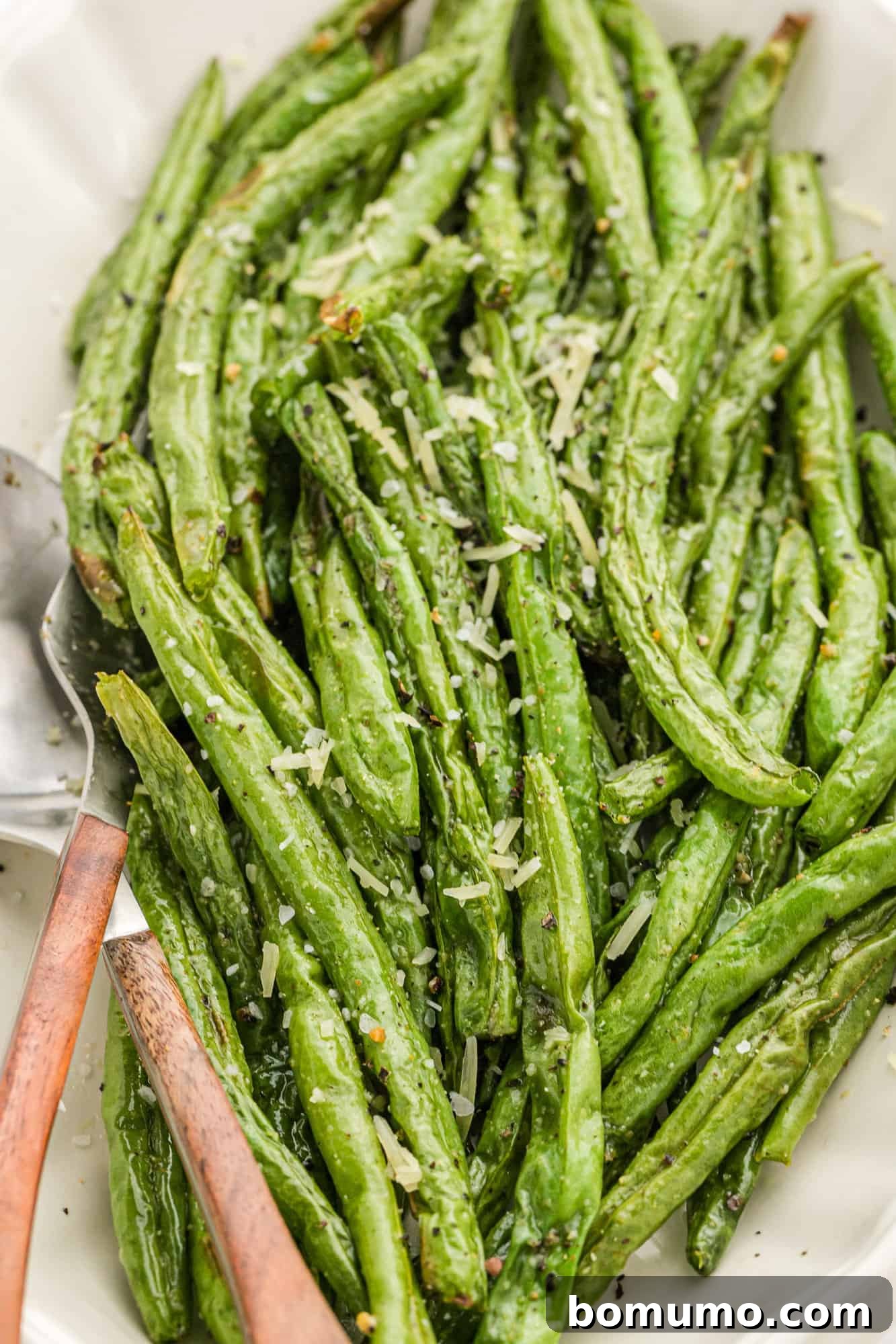 Crispy air fryer green beans served elegantly on a white platter, ready to be enjoyed.