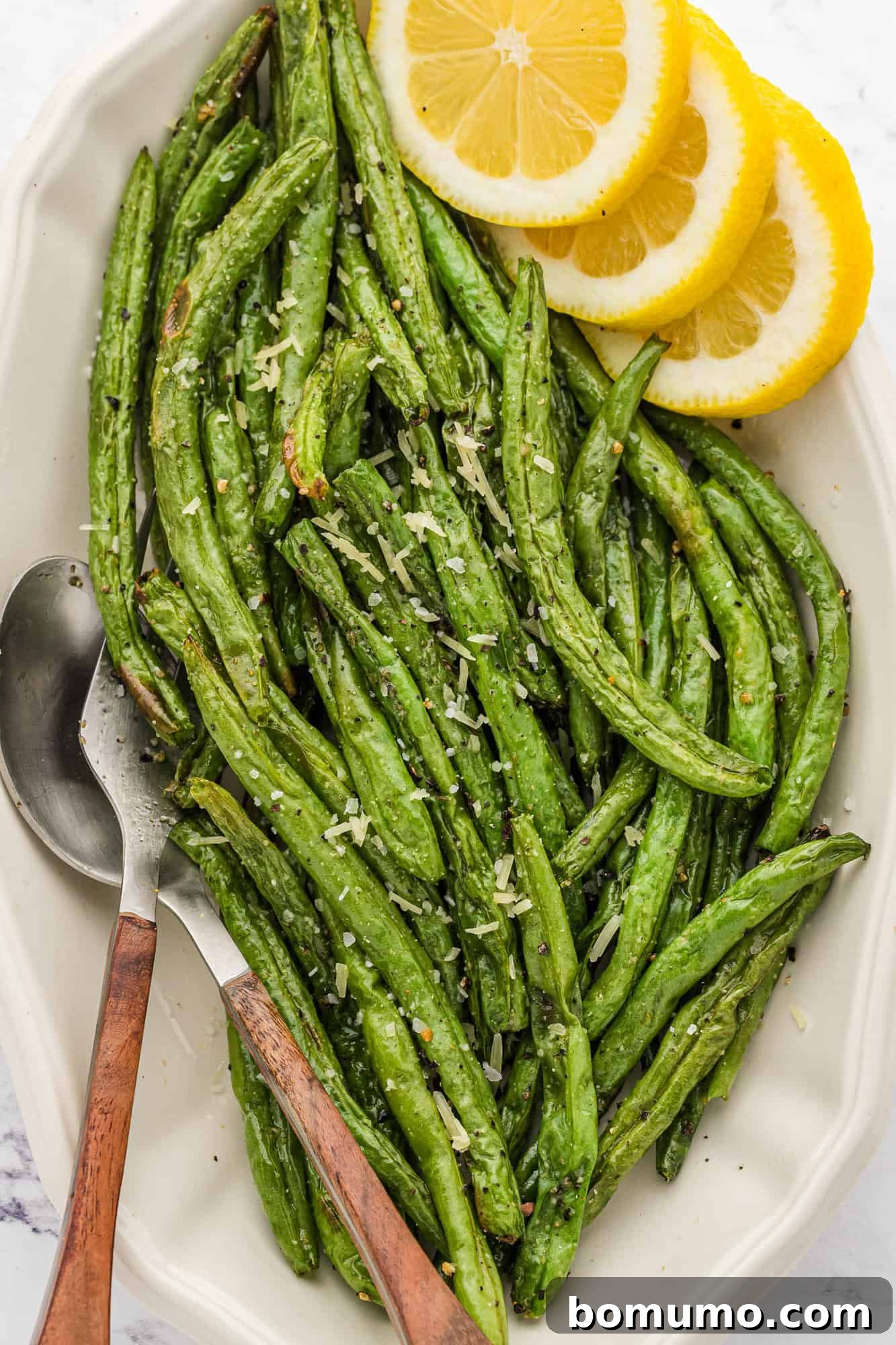 A close-up view of perfectly cooked air fryer green beans, showcasing their tender-crisp texture and browned edges.