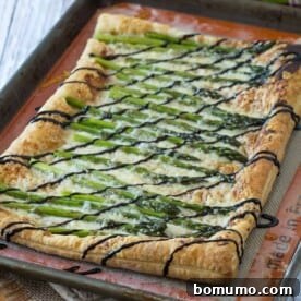 Perfect for spring, this asparagus gruyere tart is a show-stopping addition to any brunch or appetizer table. You won't believe how easy it is to make! Get the recipe on RachelCooks.com!