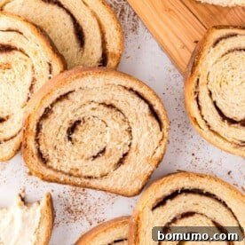 Cinnamon swirl bread cut into perfect slices, revealing its rich, swirling pattern.