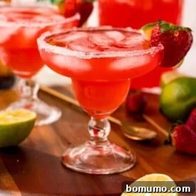 Red iced beverage in a margarita glass.