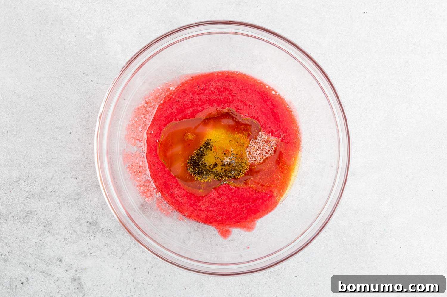 Separate ingredients for the raspberry vinaigrette before mixing, showcasing their vibrant colors and fresh quality.