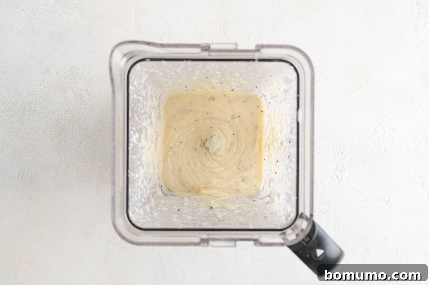 Silken Parsnip Puree 11 Creamy parsnip puree being blended to a smooth consistency.