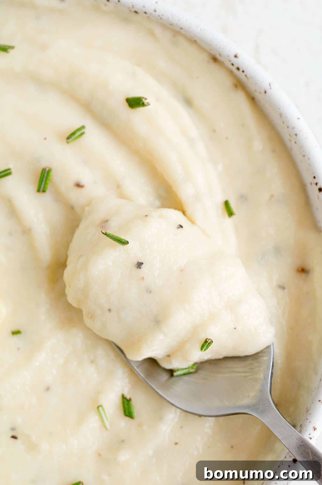 Silken Parsnip Puree 13 Parsnip puree on a spoon showing its creamy texture.