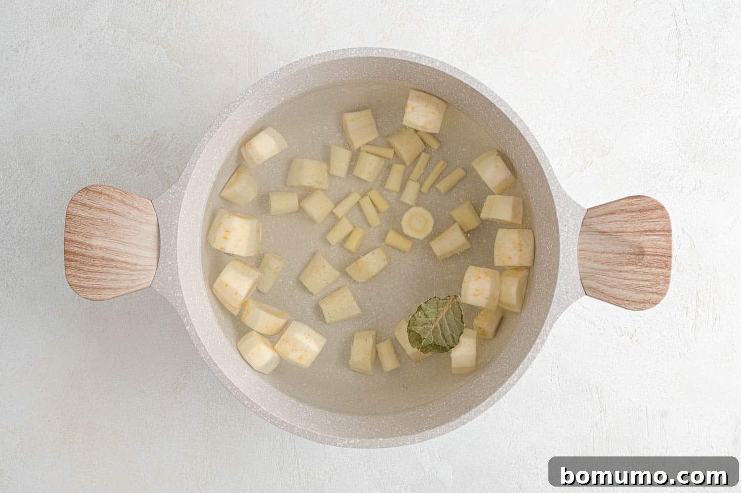 Silken Parsnip Puree 6 Parsnips being boiled in a large pot on a stovetop.