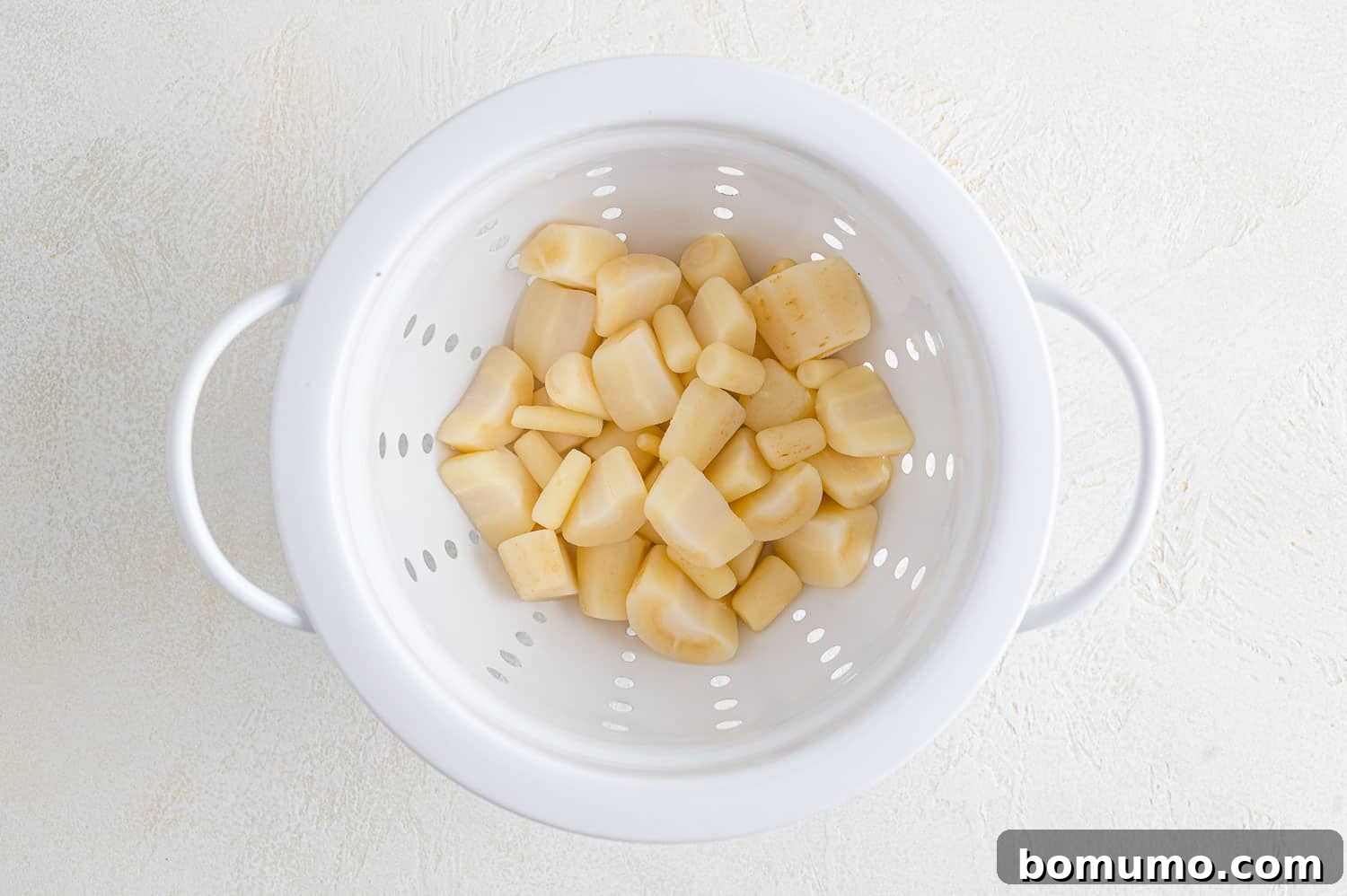Silken Parsnip Puree 8 Drained parsnips in a colander after boiling.