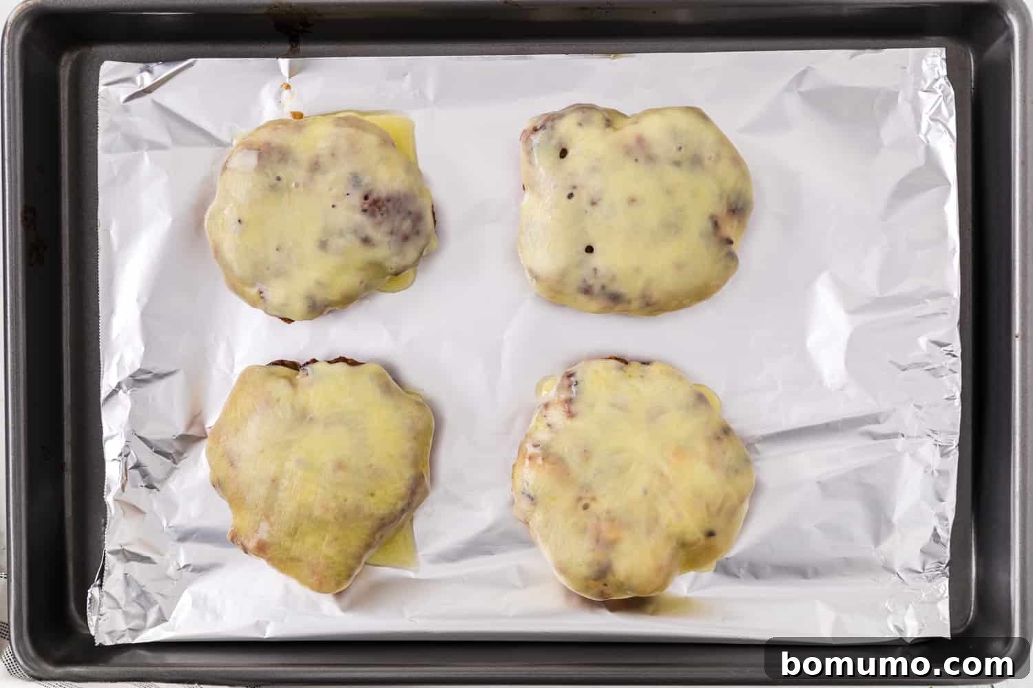 Burgers with cheese melted on them.