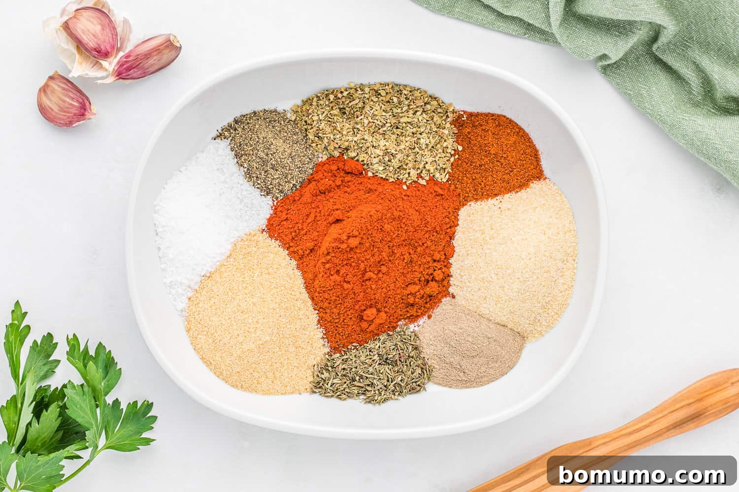 Cajun Spice Blend 6 Unmixed spices in a white bowl.