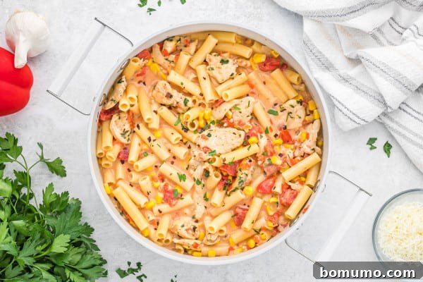 The finished creamy Cajun chicken pasta, garnished with fresh herbs.