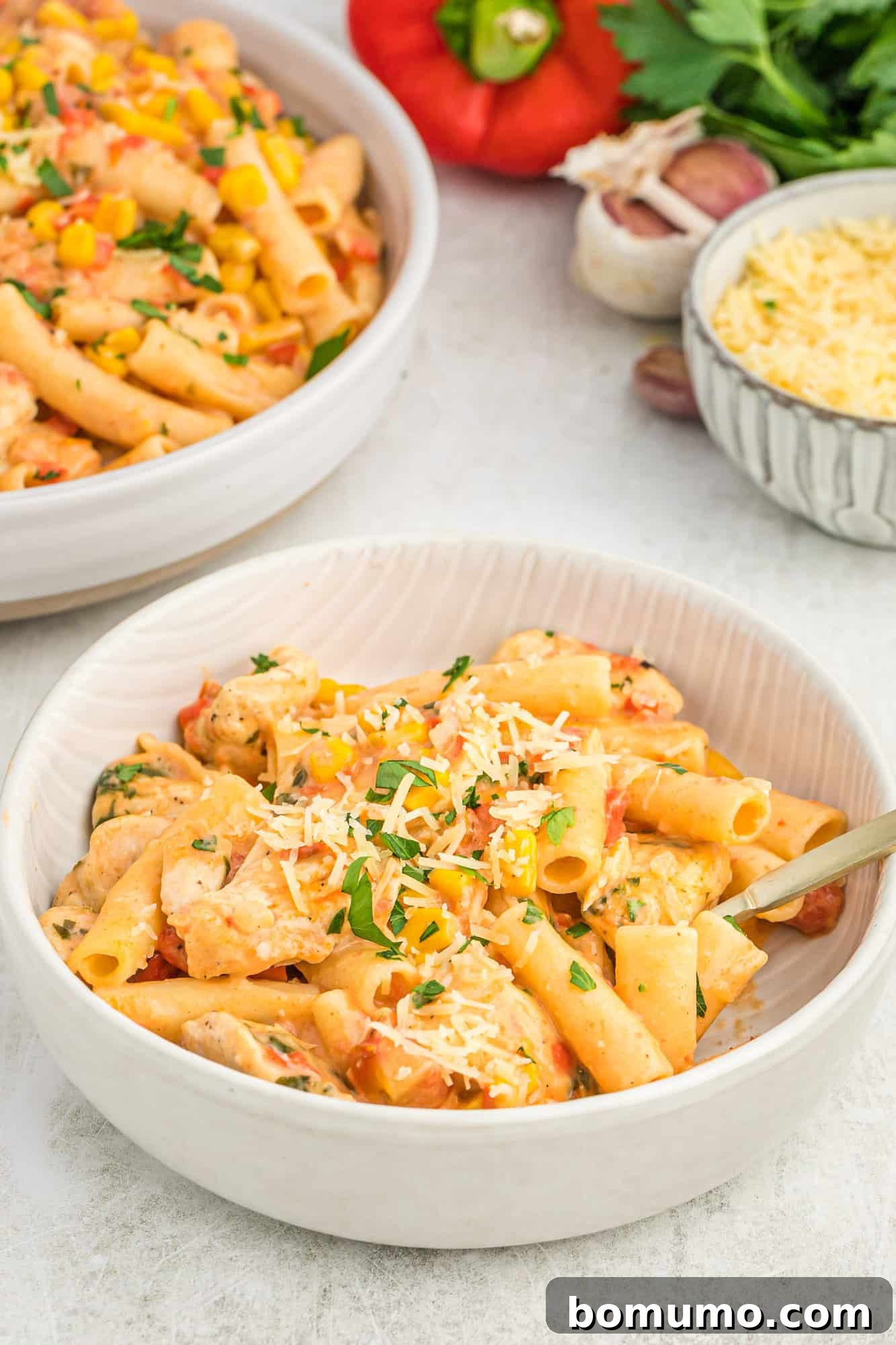 A bowl of creamy Cajun pasta, garnished with fresh herbs, ready to be enjoyed.