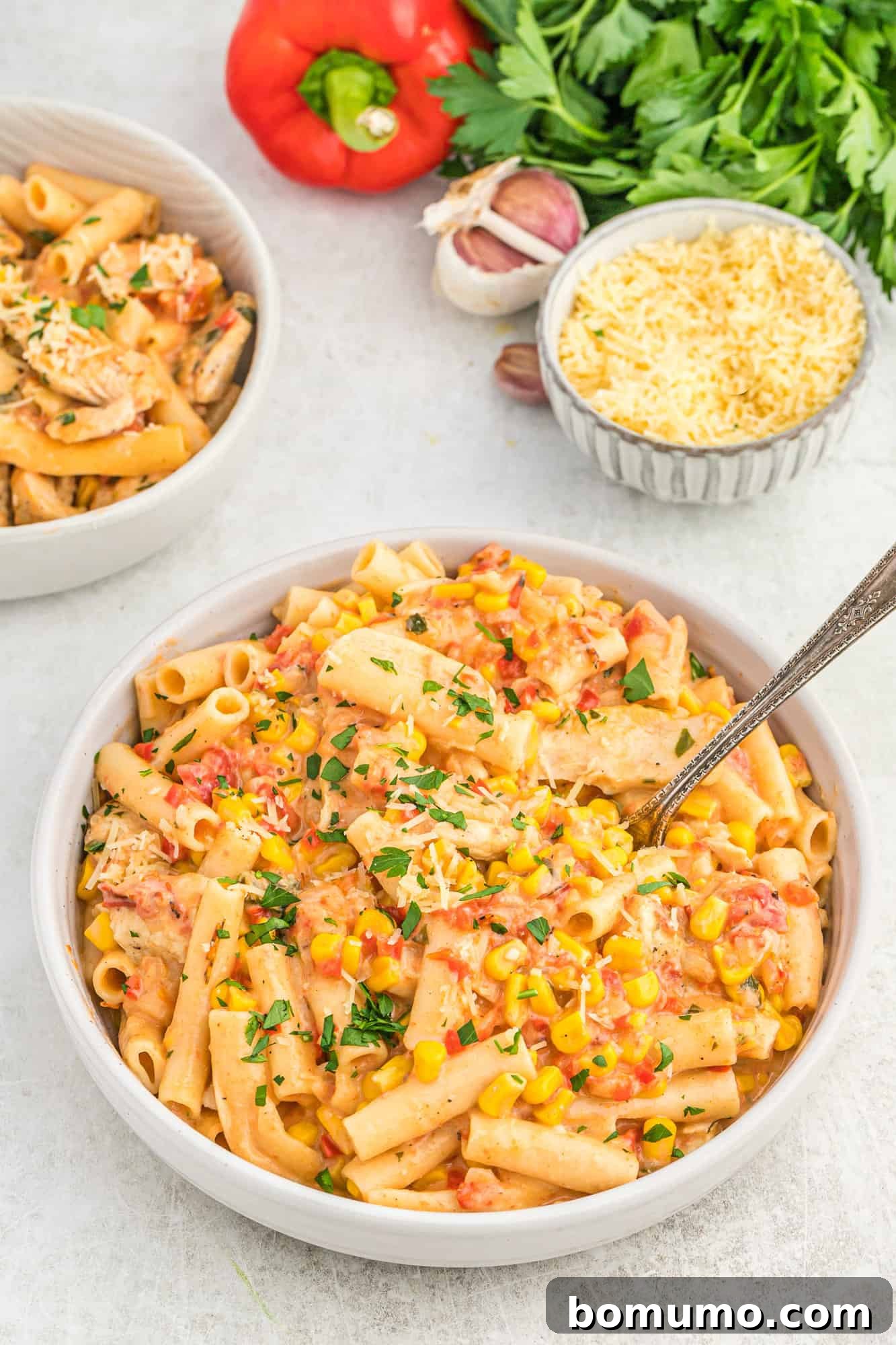 A generous serving of creamy Cajun chicken pasta with fresh parsley in a large bowl.