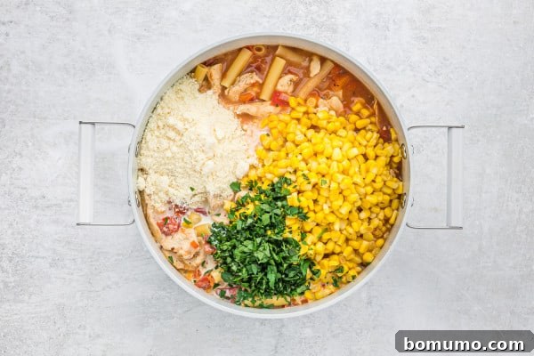 Heavy cream, Parmesan cheese, corn, and fresh parsley being added to the cooked pasta.