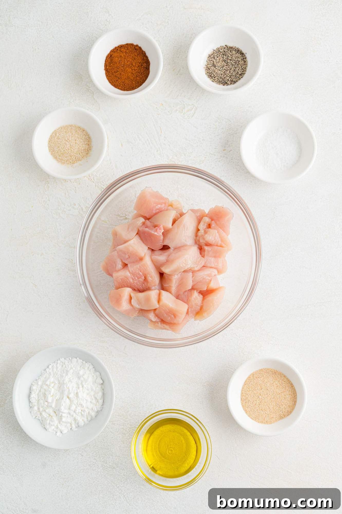 Golden Chicken Bites 4 A vibrant flat lay image showcasing all the fresh ingredients required to make delicious chicken bites, including chicken breast, spices, and olive oil.