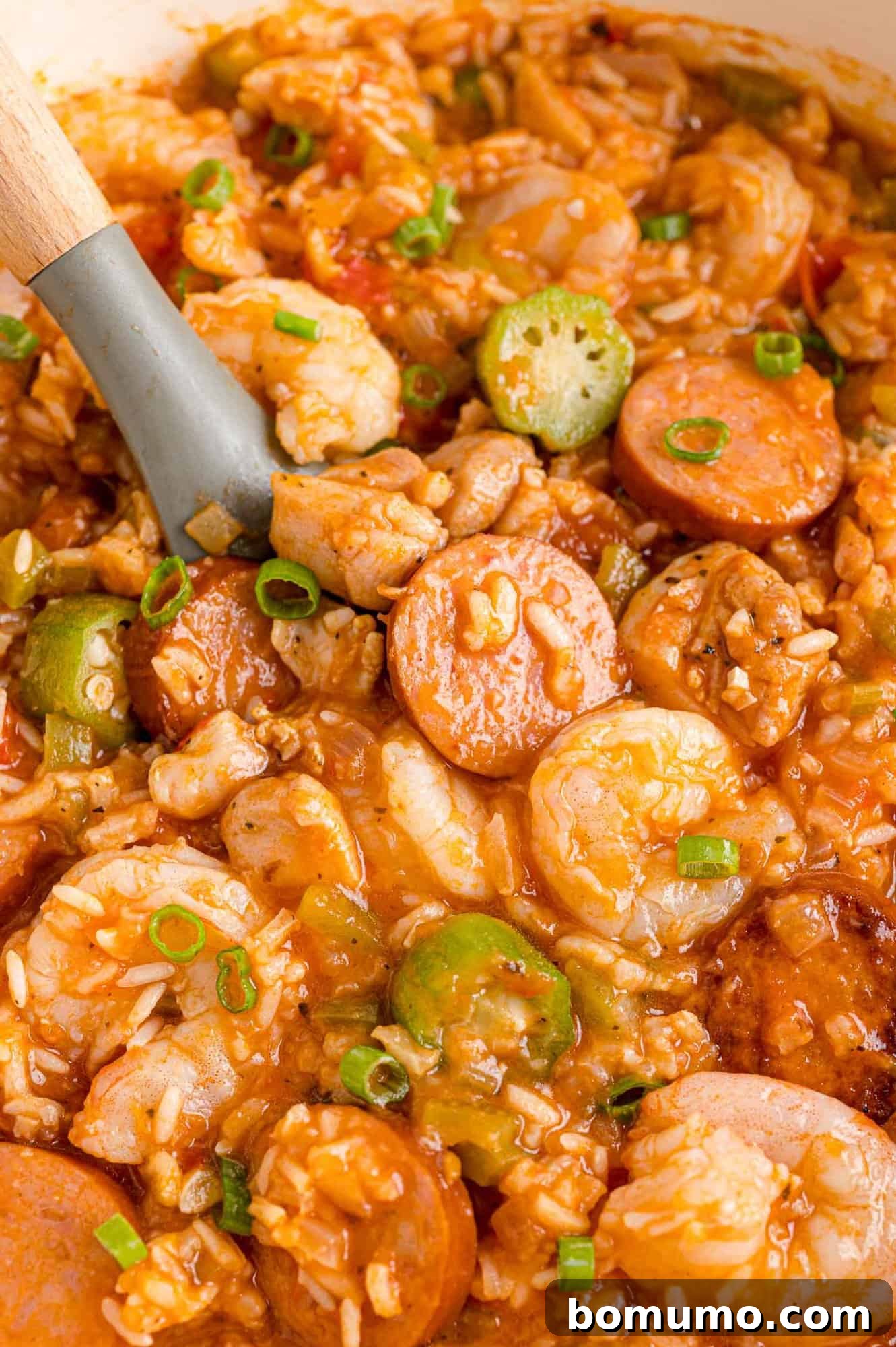 Jambalaya in a pan with serving spoon.