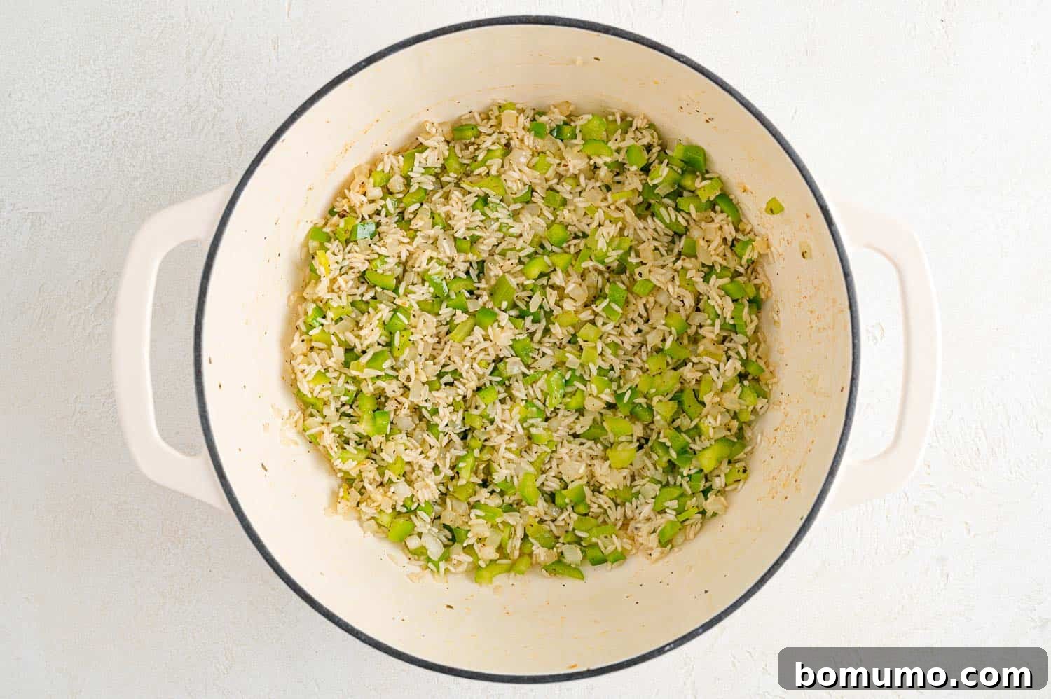 Rice and seasonings added to pan.