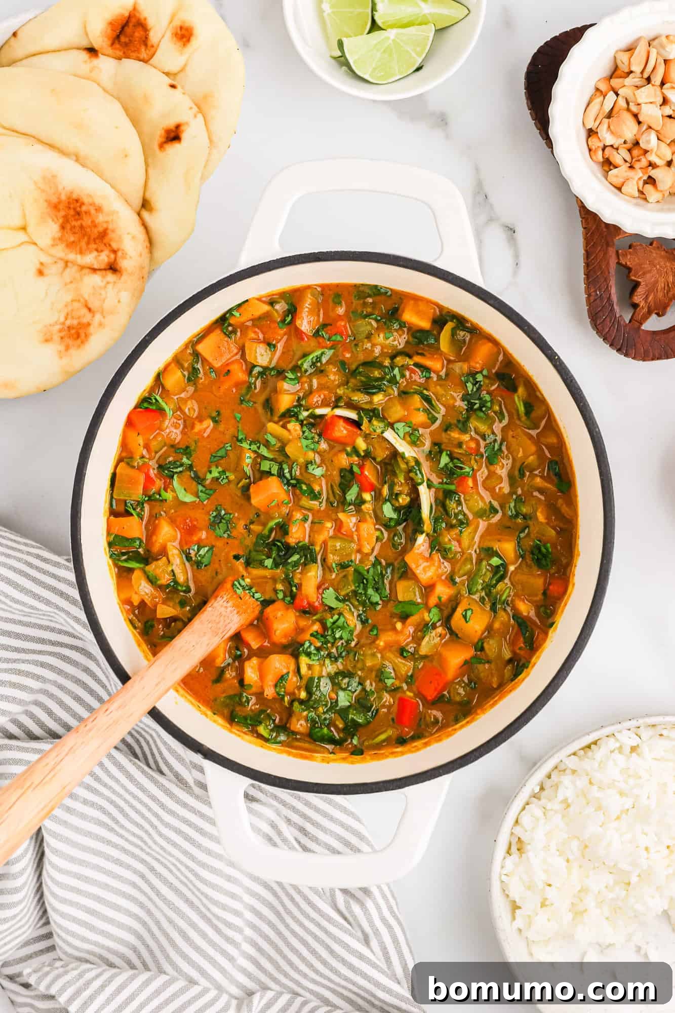 The finished butternut squash curry, rich and creamy, simmering in a large pot, ready to be dished out and enjoyed.