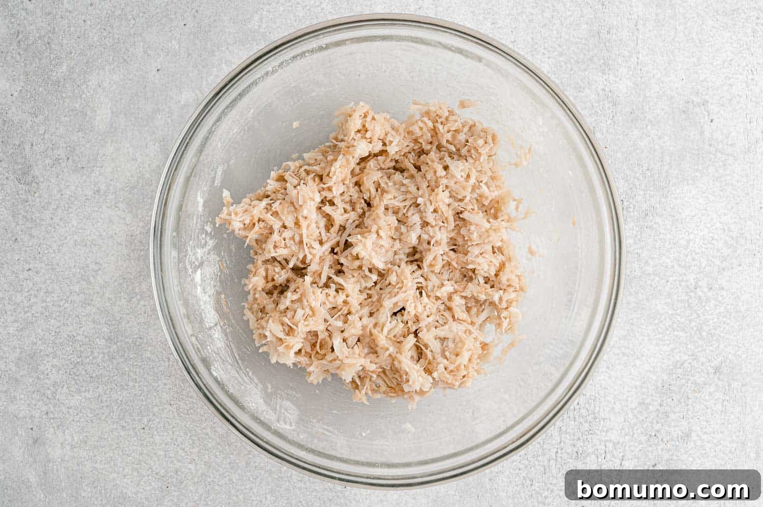 Chewy Coconut Delights 7 The unbaked coconut macaroon mixture, sticky and cohesive after combining with egg whites and vanilla.