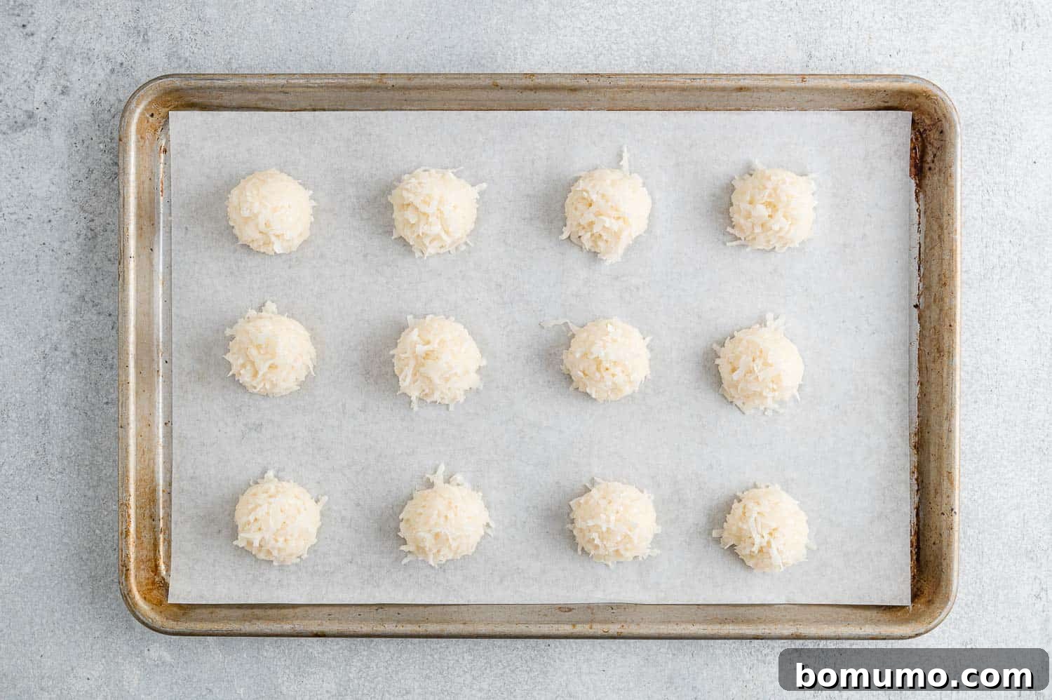 Chewy Coconut Delights 9 A batch of coconut macaroons made with clear vanilla extract, exhibiting a brighter, whiter appearance.